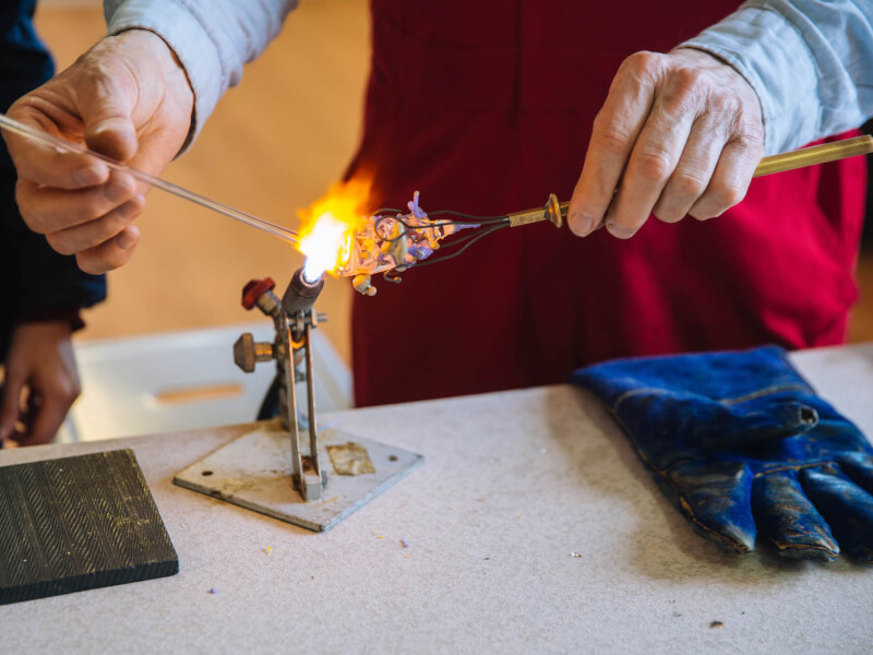 Close up of glass being put to the flame at a Melbourne glassblowing class